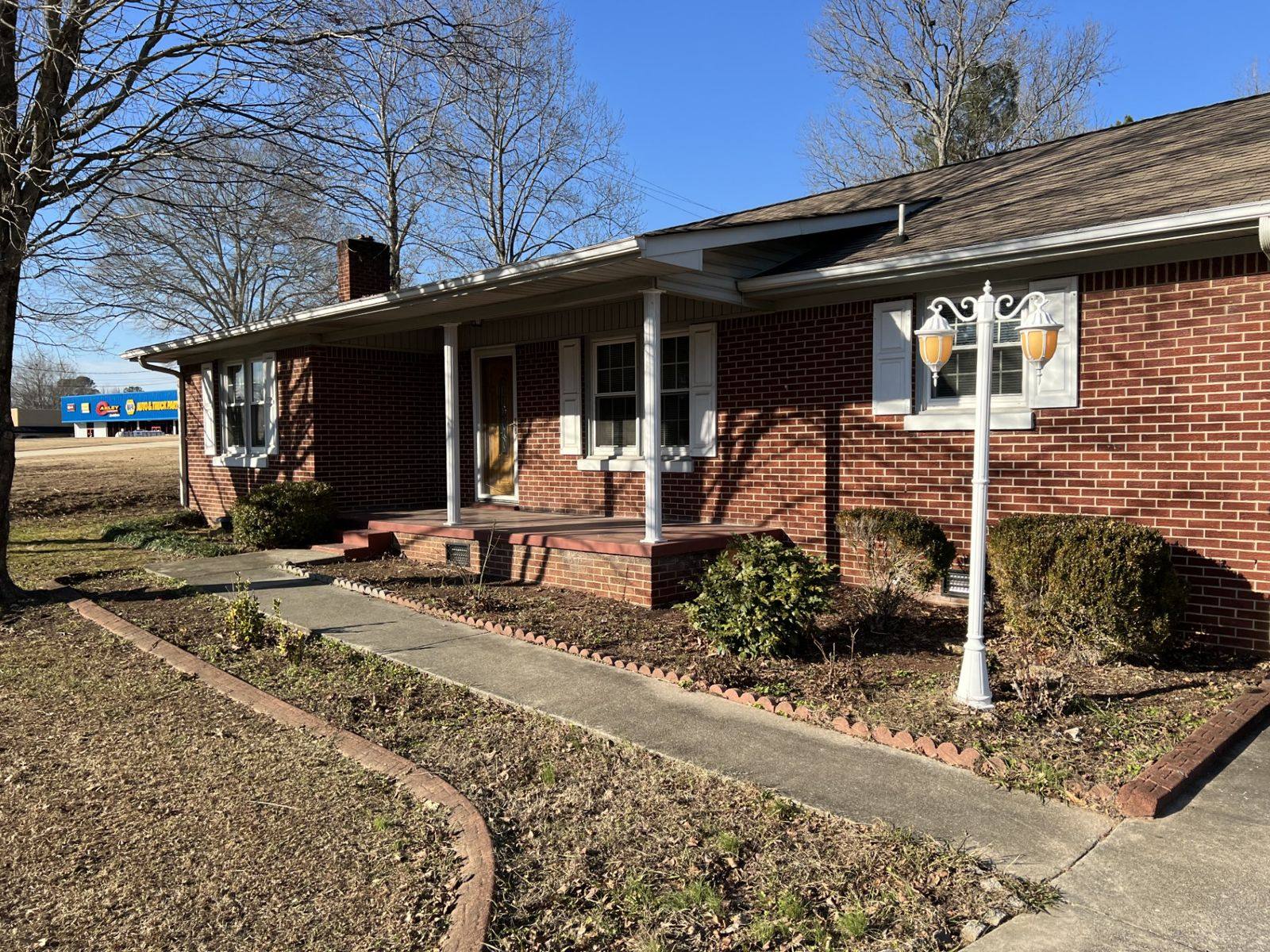Red brick Oakley rental house with a covered front porch