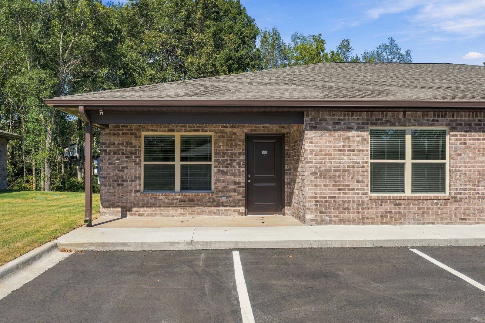 Brick duplex at The Oaks at Whites Lake with woods behind